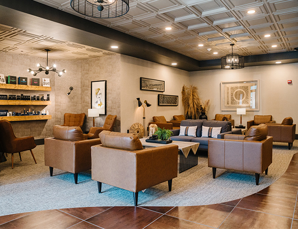 Office waiting area with a couch and comfortable chairs.